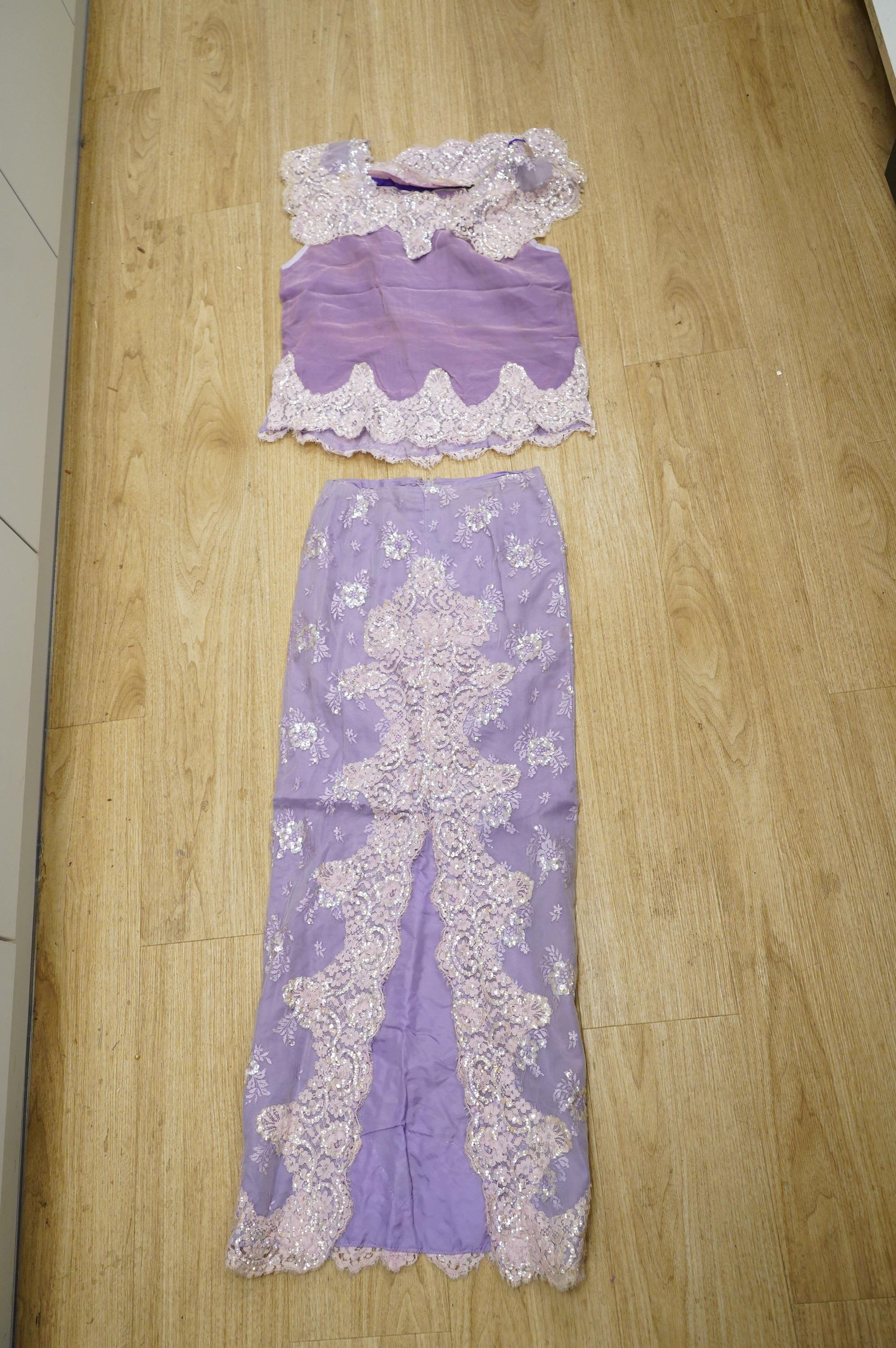 A late 20th century black sequinned, beaded and fringed evening dress, bust 36cm wide at front, together with a lilac chiffon, net, lace and sequin top and matching net evening skirt. Both outfits are a small size